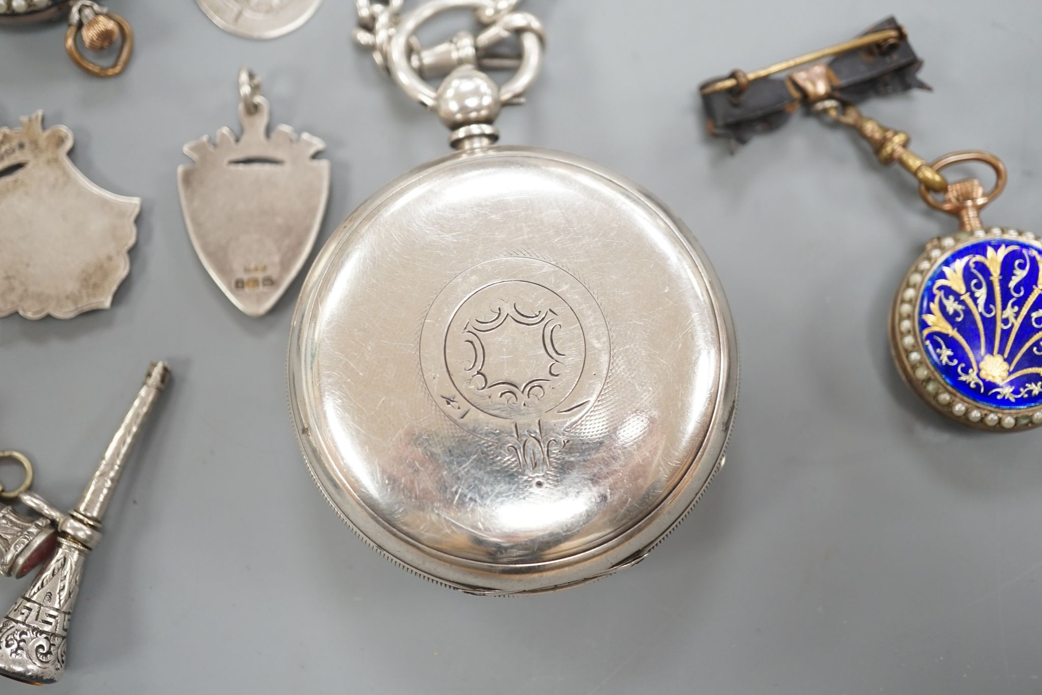 A George V silver open faced lever pocket watch, by A. Yewdall, Leeds, on a silver albert hung with silver medallions, two Swiss white metal and enamel fob watches, gilt fob seal, etc.